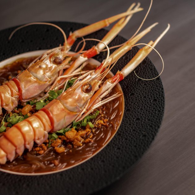 Roasted scampi, anise-myrtile spiced bacon and glass noodles